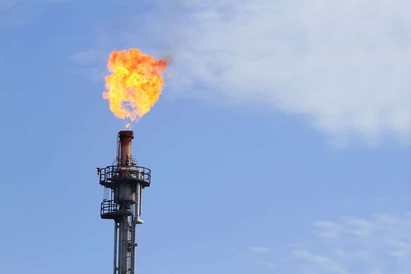 14752473 - burning oil flare on a blue sky